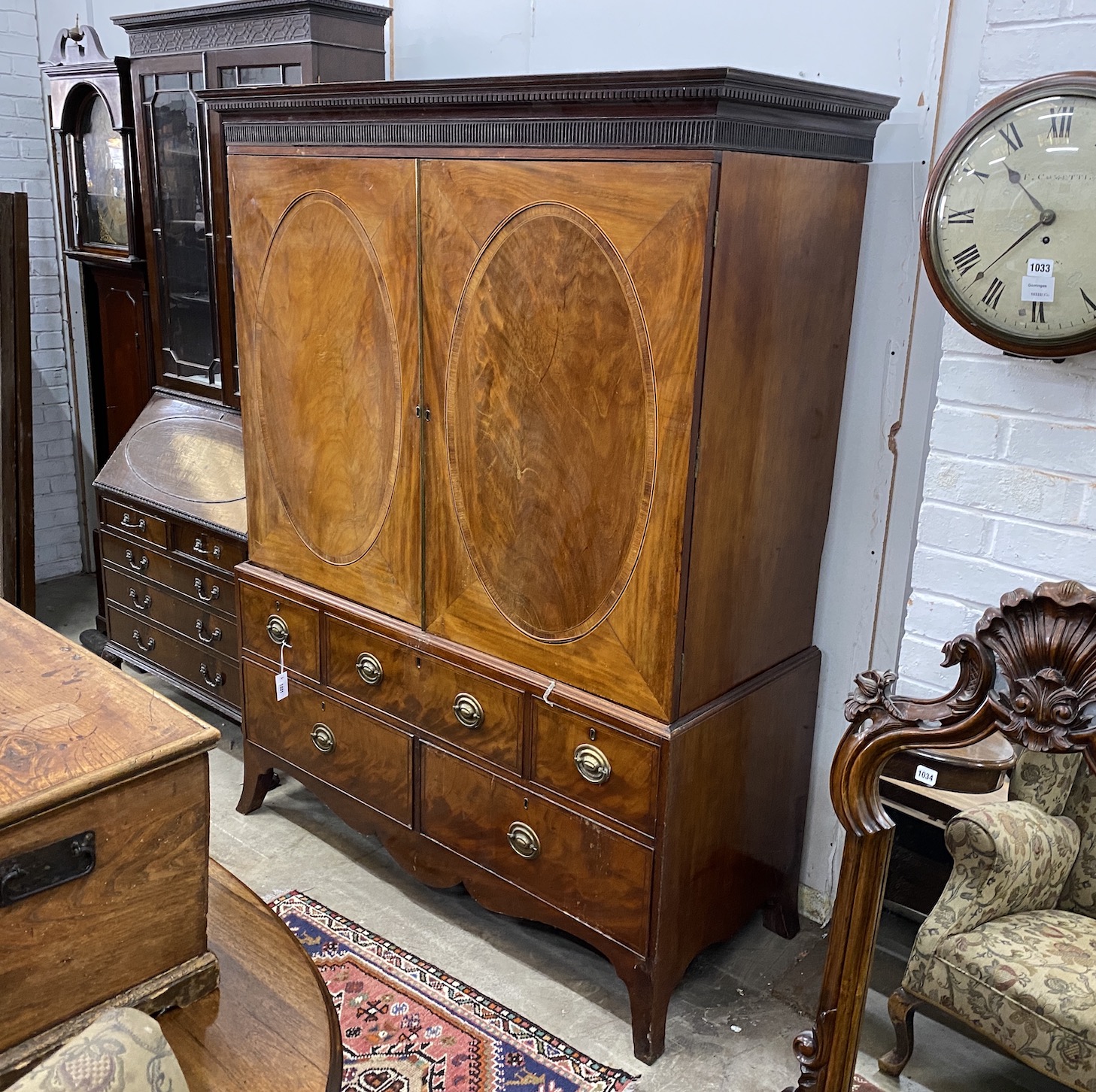 A George III banded mahogany linen press converted to a hanging wardrobe, width 147cm, depth 64cm, height 191cm